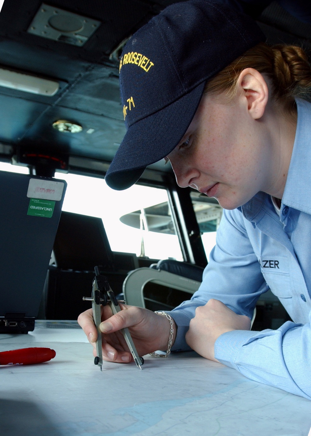 Navy Petty Officer 3rd Class Sarah Eleazer plots the position of the USS Theodore Roosevelt (CVN 71).