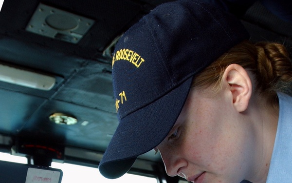 Navy Petty Officer 3rd Class Sarah Eleazer plots the position of the USS Theodore Roosevelt (CVN 71).