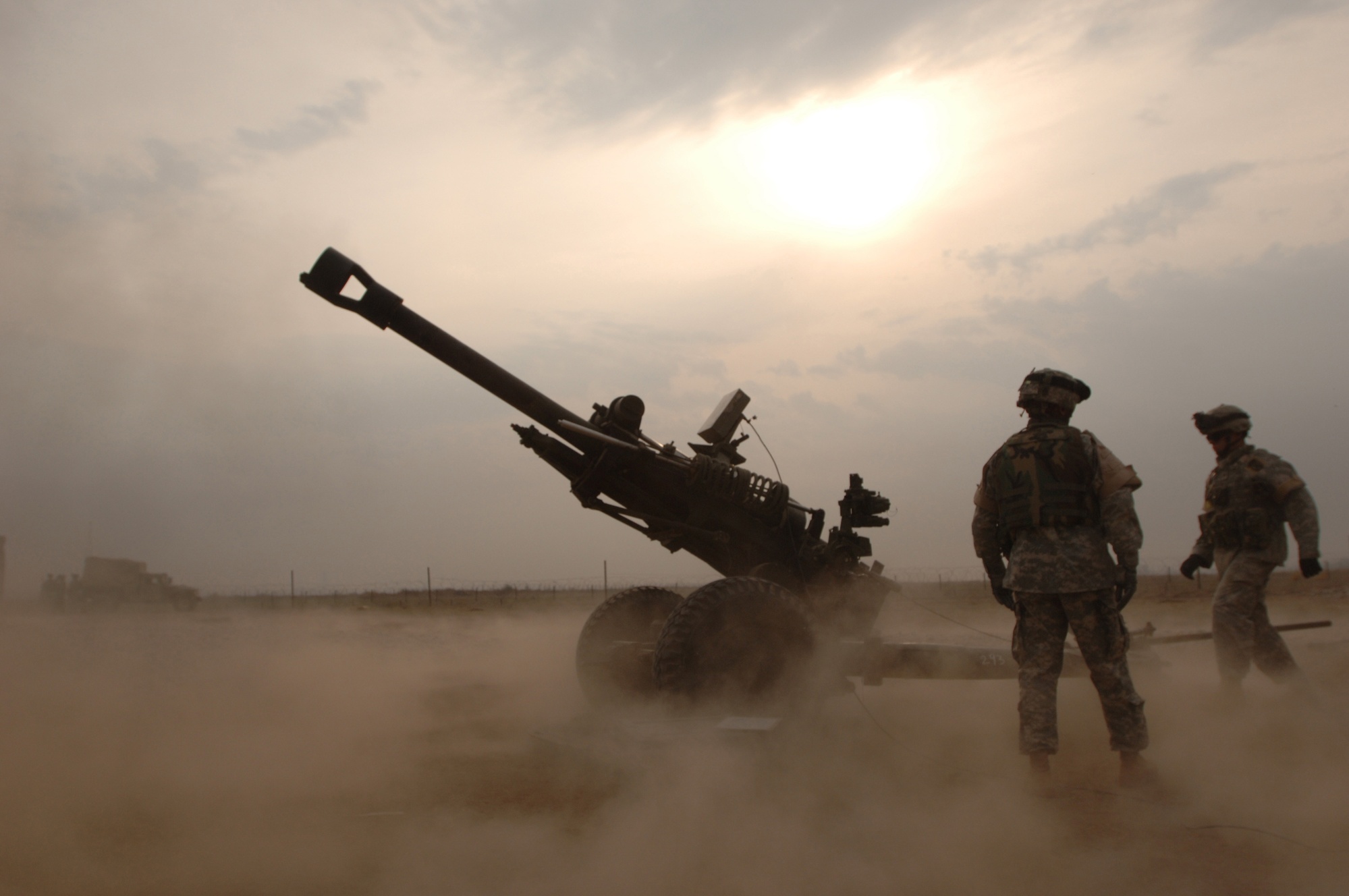U.S. Army soldiers train with an M119 howitzer outside Camp Liberty in Iraq