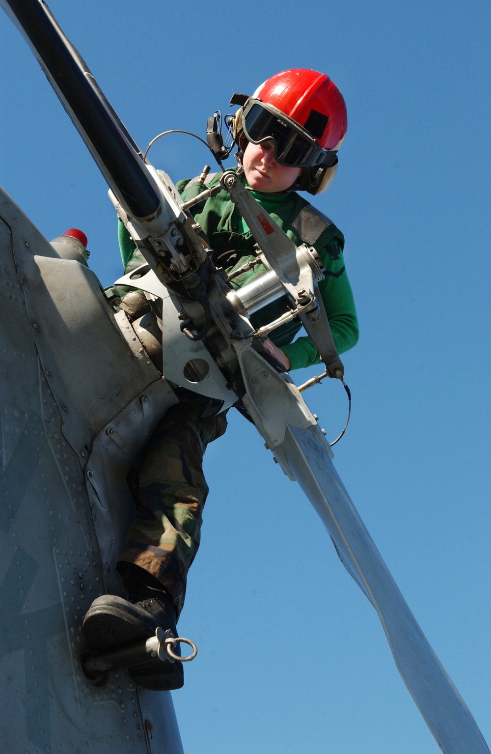 Navy Petty Officer 3rd Class Andrea Schofield conducts a preflight inspection on the tail rotor of an SH-60F Seahawk.