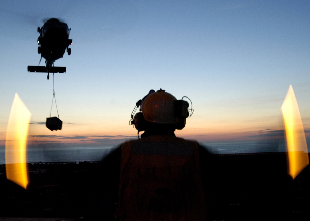 DVIDS - Images - A flight deck crewman uses flashlight wands to direct ...