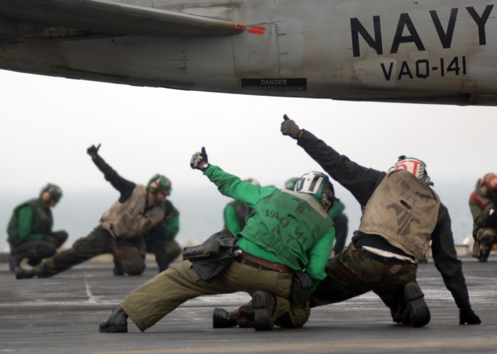 U.S. Navy flight deck crewmen give the thumbs up to signal everything is okay.