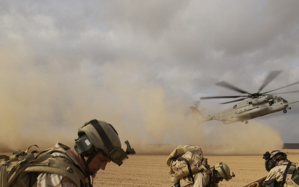 U.S. Air Force pararescuemen place simulated injured victims on stretchers.