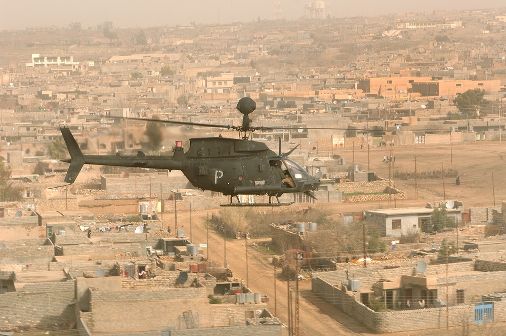 A U.S. Army OH-58D Kiowa helicopter conducts a combat air patrol over the city of Tall Afar.