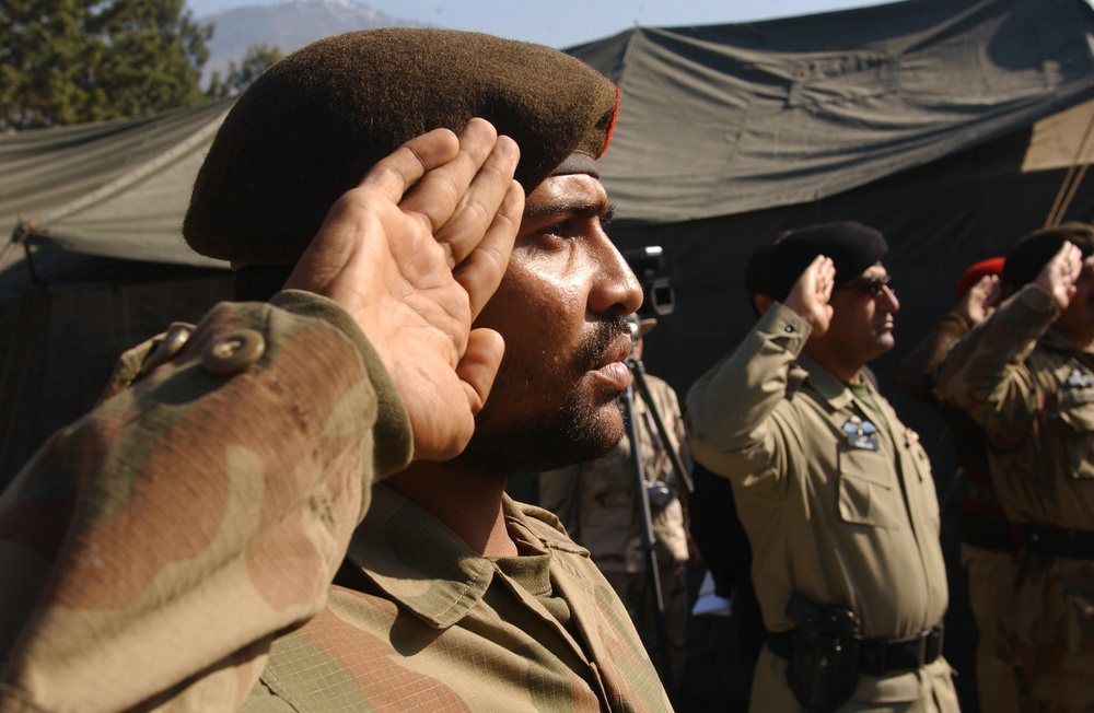 Pakistan army soldiers salute during a transfer of authority ceremony.