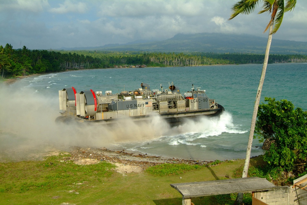 A Navy Landing Craft Air Cushion enters the surf from the island of Jolo, Philippines.