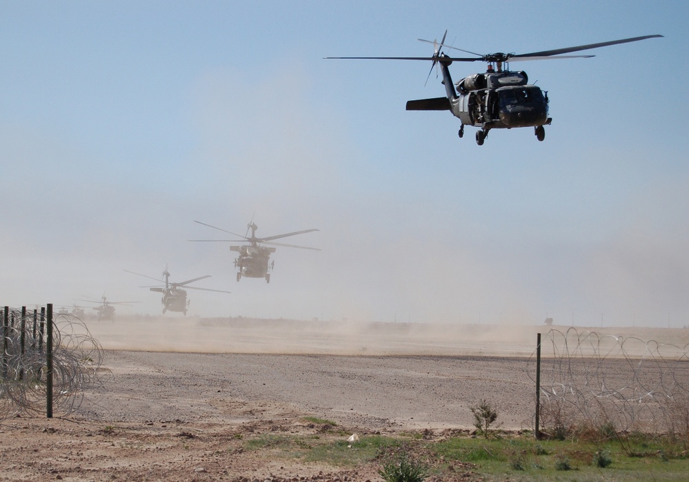 U.S. Army UH-60 Black Hawk helicopters lift off from Forward Operating Base Remagen.