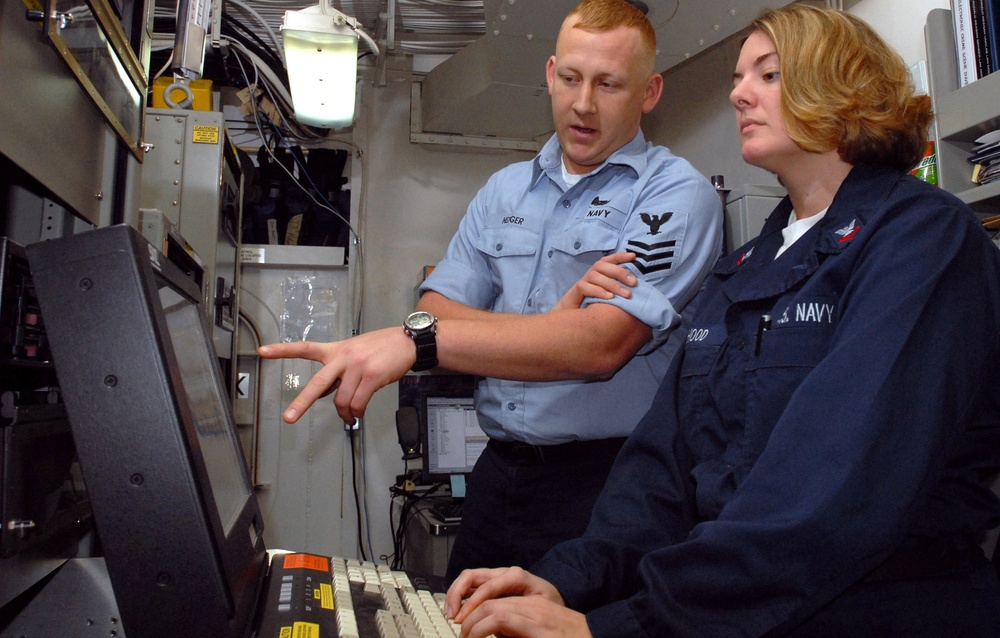 Petty Officer 1st Class Chris Hedger trains Petty Officer 2nd Class Susan Hood.