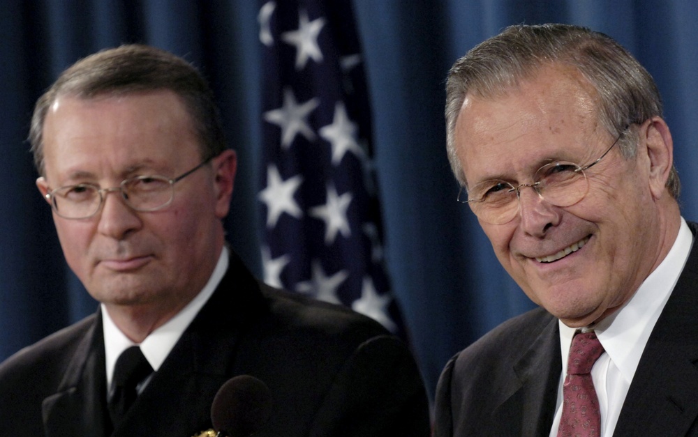 Secretary Rumsfeld and Adm. Giambastiani listen to a question during a Pentagon press briefing.