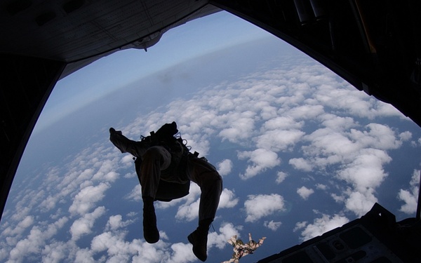 An Air Force pararescueman does a back flip.