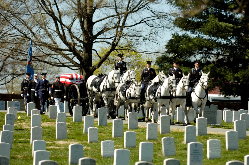 A joint service honor guard escorts the caisson.