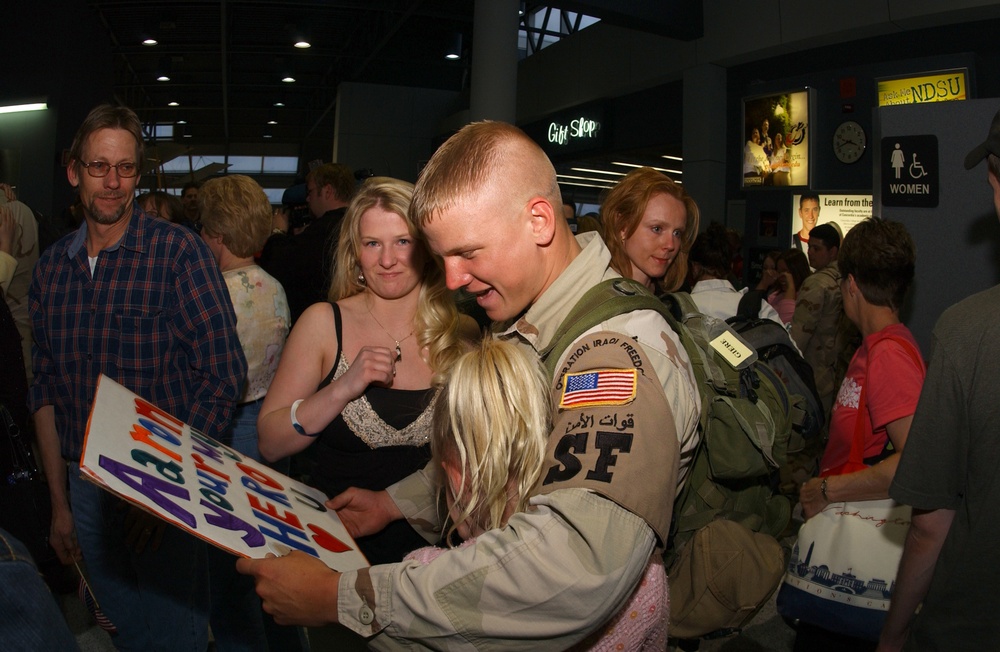 Air Force Staff Sgt. Aaron D. Giere reads a hand-lettered sign.