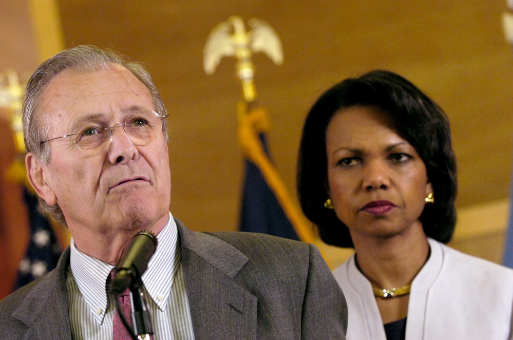 Secretary Rumsfeld speaks to reporters as Secretary of State Condoleezza Rice listens.