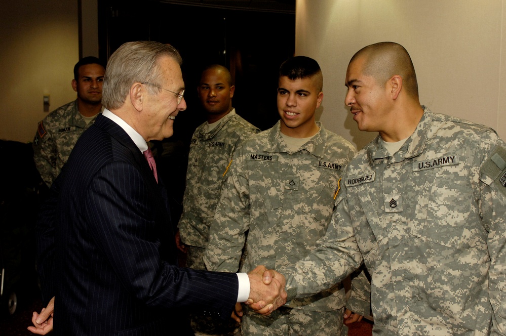 Secretary Rumsfeld greets and speaks with Army soldiers.