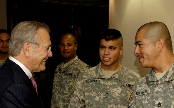 Secretary Rumsfeld greets and speaks with Army soldiers.
