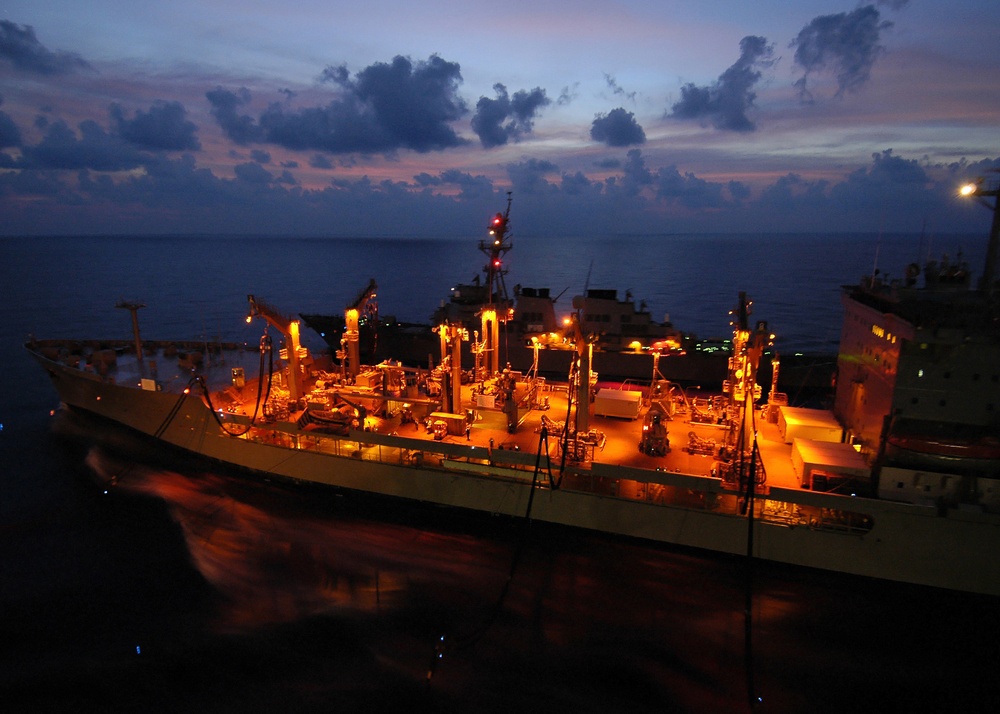The USNS Yukon (T AO 202) and the USS Russell (DDG 59) steam alongside.