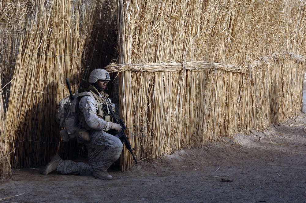 U.S. Marine Corps Cpl. Julius Mitchell scans the area while on patrol.