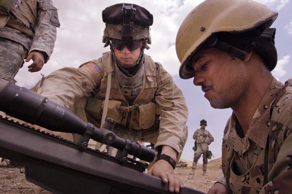 Spc. Michael Florczykowski instructs an Iraqi army soldier.