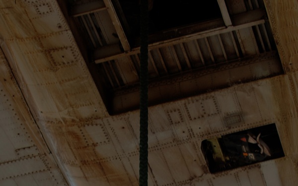 A U.S. Army soldier fast ropes from a helicopter.