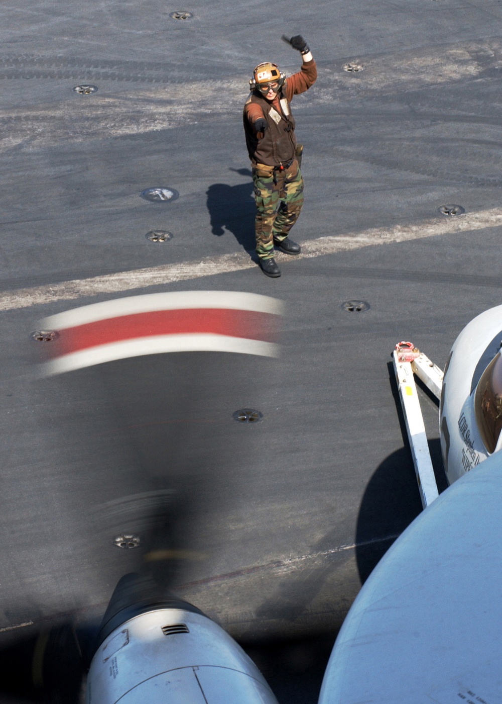 A U.S. Navy plane captain gives the &quot;start-engine&quot; signal.