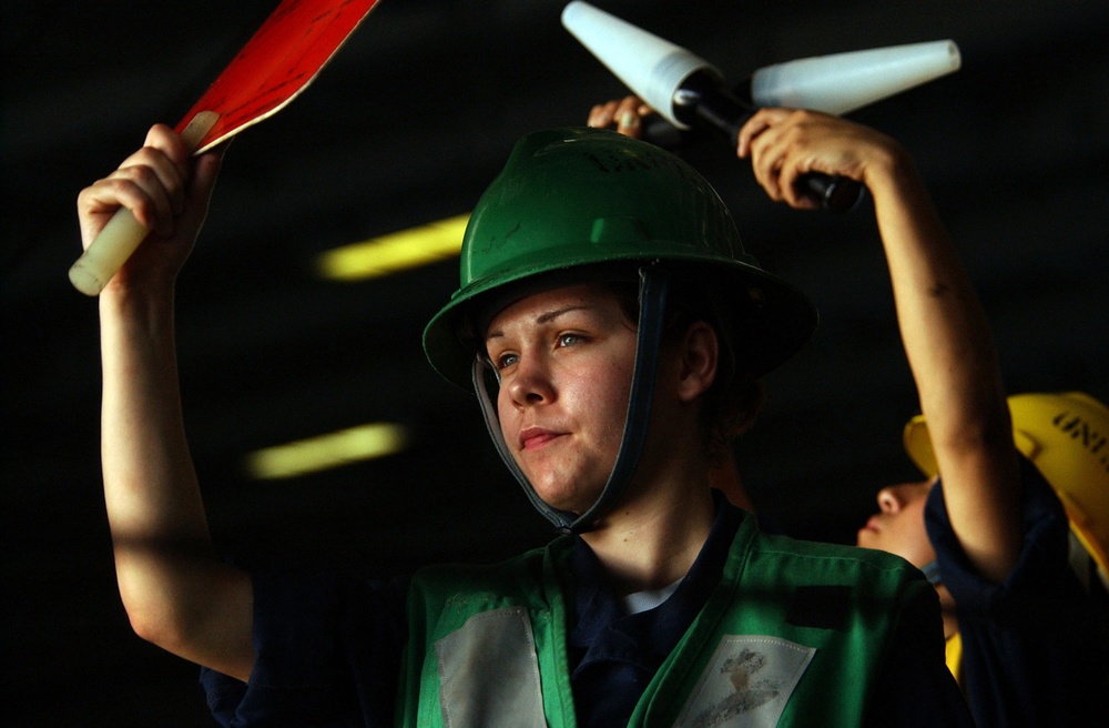 DVIDS - Images - Navy Seaman Kelly Caccamise signals the passing of cargo.