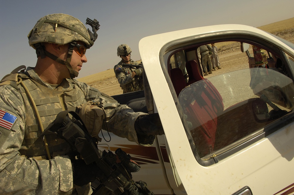 Army Spc. Alexander Jordan searches a truck during an aerial traffic control point mission.