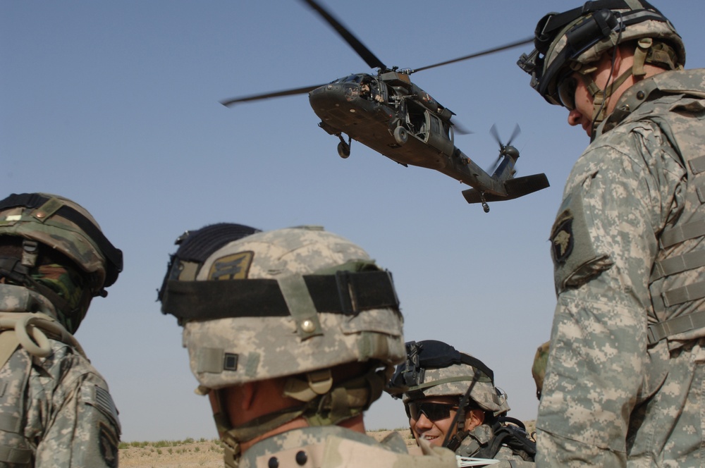 An Army UH-60 Black Hawk helicopter descends to extract U.S. Army soldiers.