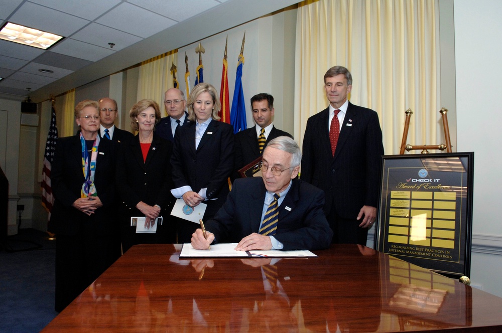 Deputy Secretary of Defense Gordon England signs the memorandum announcing the &quot;Check It&quot;
