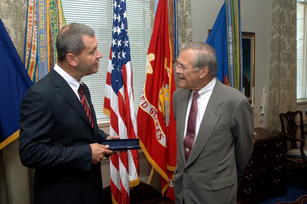 Latvian Minister of Defense Atis Slakteris talks with Secretary Rumsfeld.