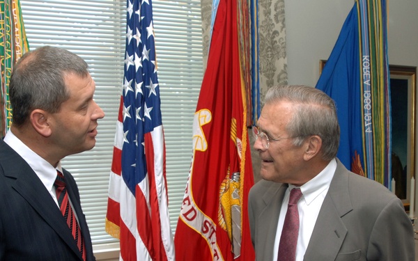 Latvian Minister of Defense Atis Slakteris talks with Secretary Rumsfeld.