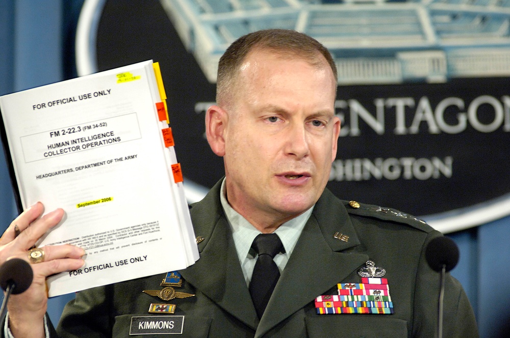 Lt. Gen. John Kimmons holds up a copy of the Army Field Manual.