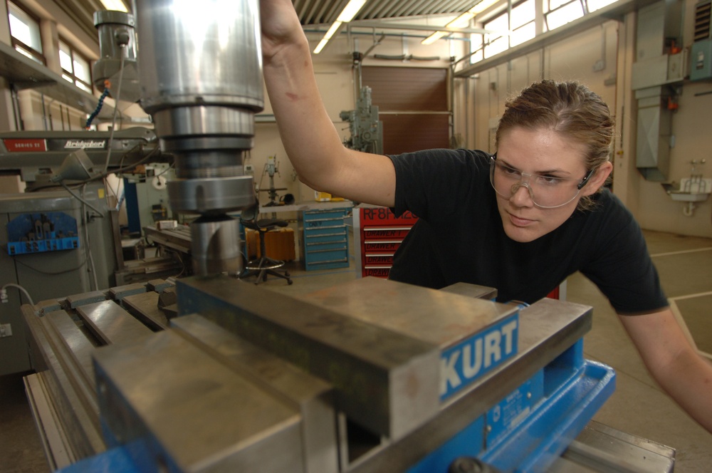 U.S. Air Force Senior Airman Michele Wilkes smoothes out a piece of metal.