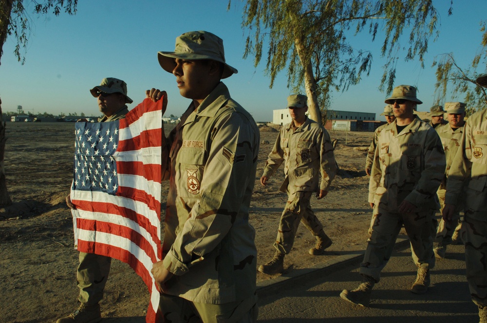 U.S. Air Force Airmen carry the American flag.