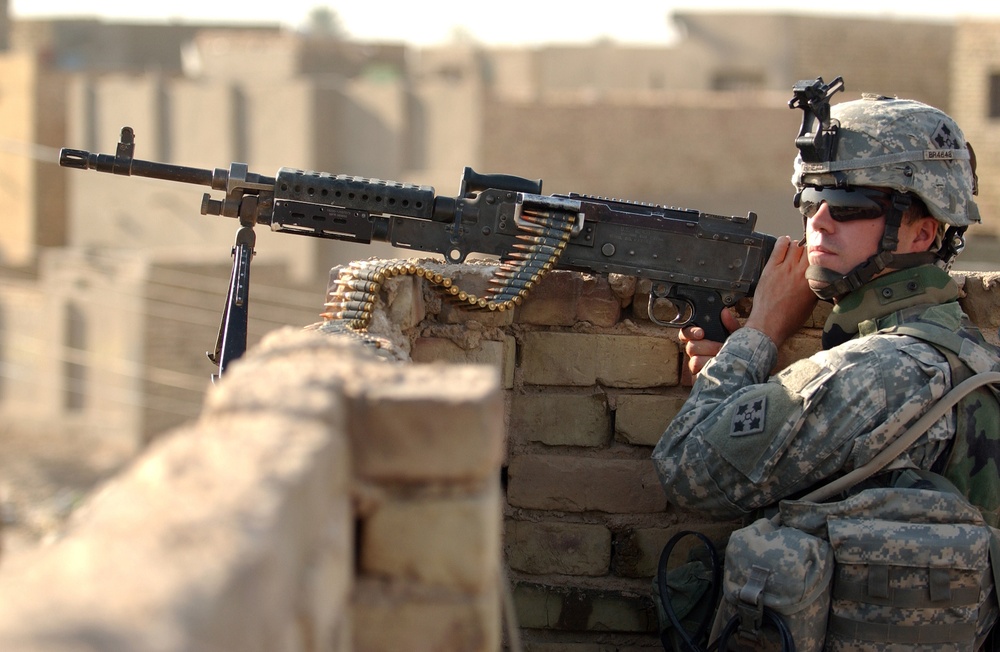 Army Spc. Eric Leon mans an M-240B machine gun.
