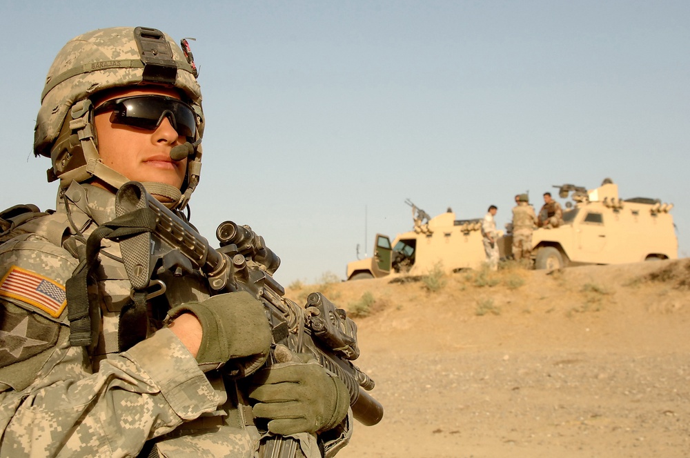 Spc. Arturo Barajas provides security for Iraqi army soldiers.