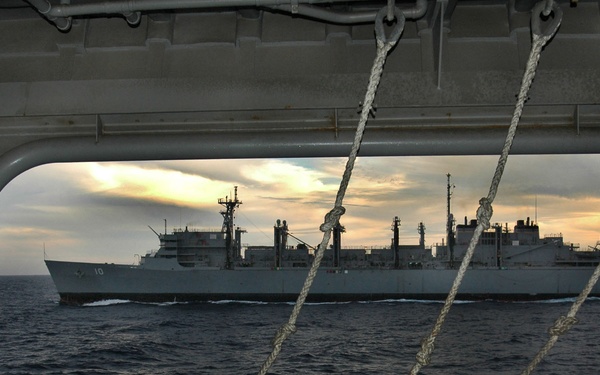 An HH-60H Seahawk helicopter delivers supplies to the USNS Bridge (T-AOE 10).