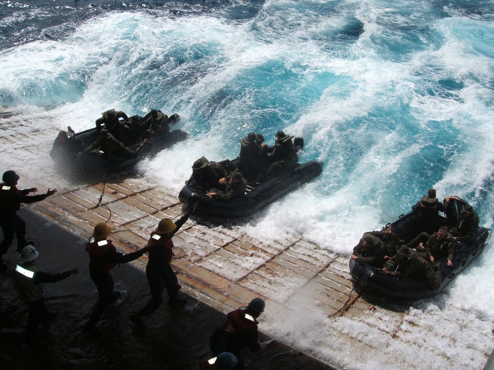 U.S. Navy sailors in combat rubber raiding craft are recovered.