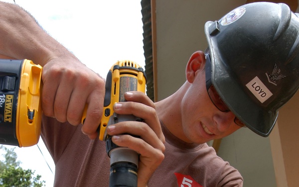 Petty Officer 3rd Class David Loyd uses a 3/8&quot; cordless drill.