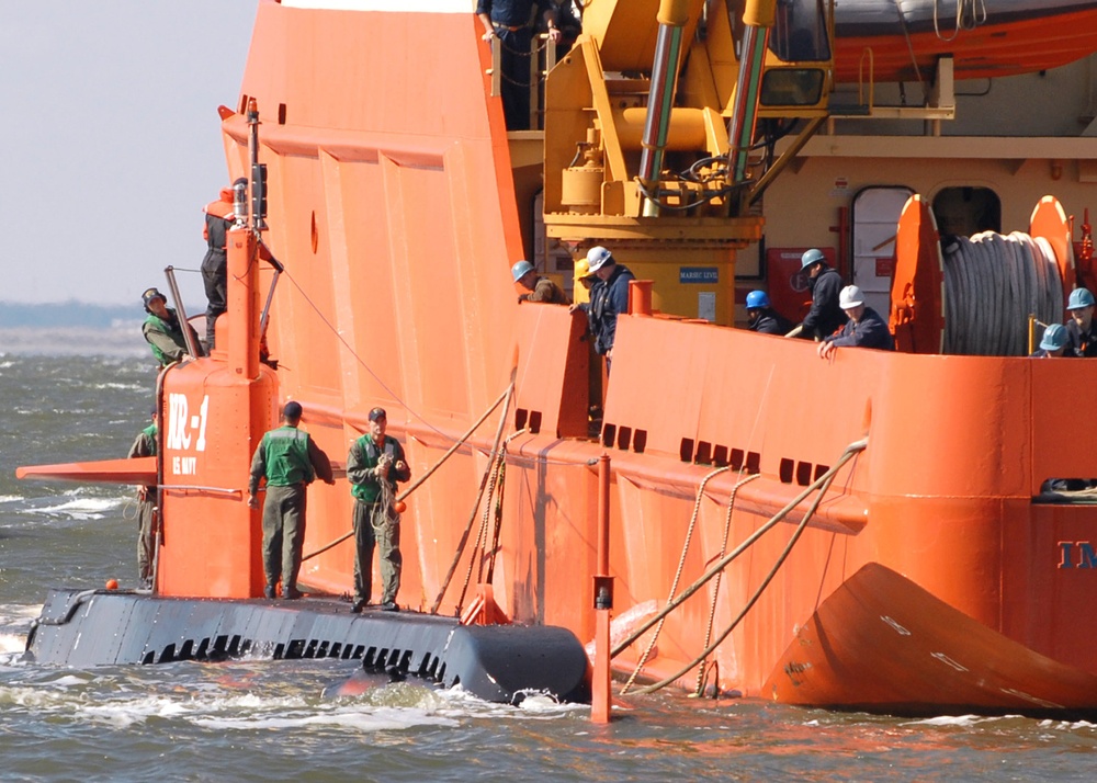 The Naval research submarine NR-1 docks alongside a submarine support ship.