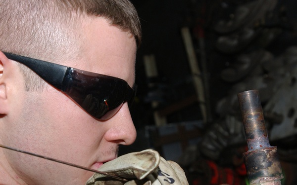 Fireman James Sawyer brazes a pipe.