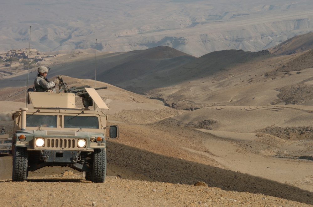 Pfc. Raymond Purtee watches the barren hills around him.