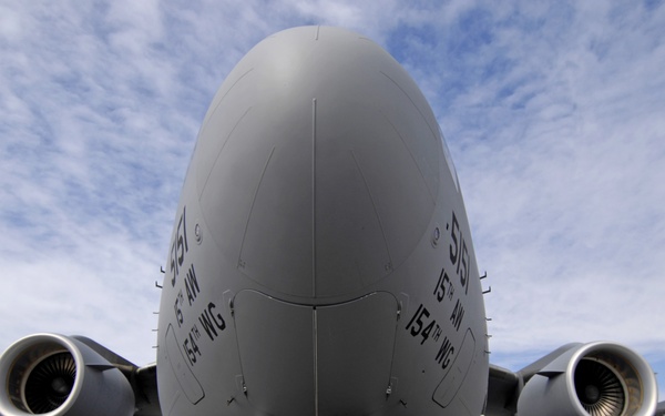 U.S. and Australian Air Force maintenance personnel work on a C-17.