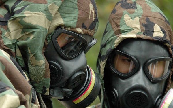 Petty Officer 2nd Class Ian Jordan and Lt. j.g. Eric Hui run tests on suspected substances.