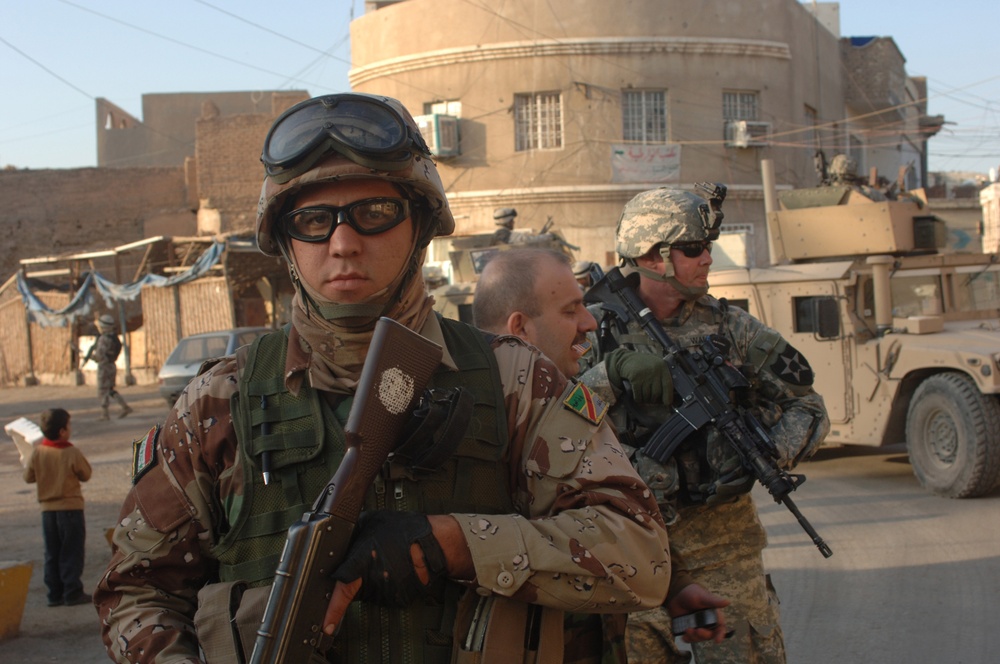Iraqi army soldiers conduct a combined patrol with U.S. Army soldiers.