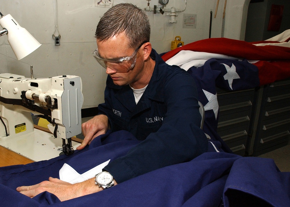 Airman Keith Whitworth manufactures a national ensign.