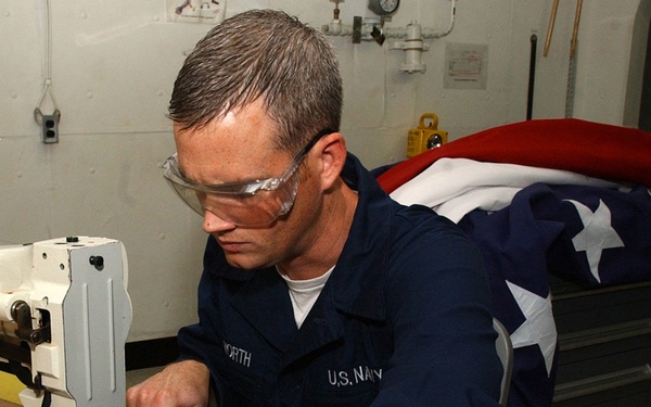 Airman Keith Whitworth manufactures a national ensign.