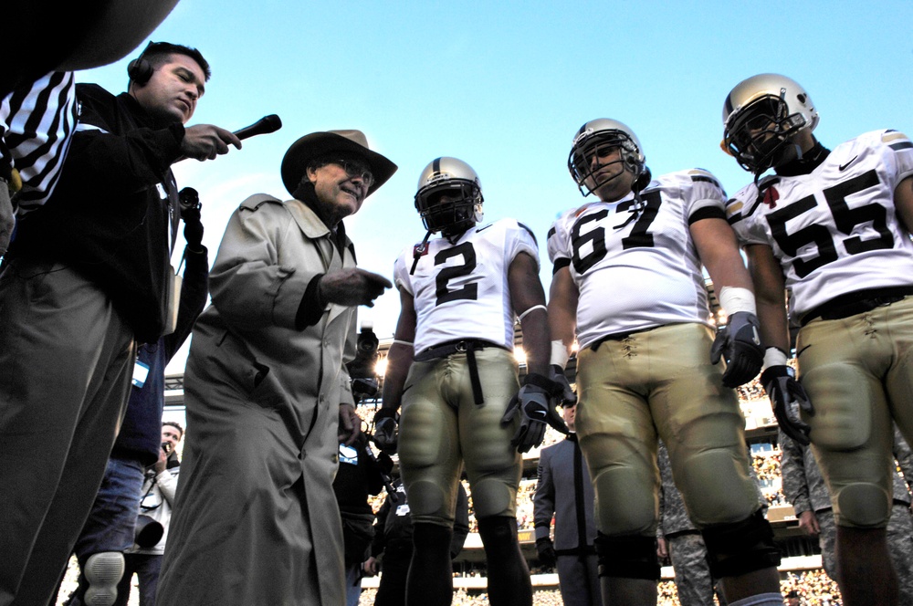 Secretary Rumsfeld prepares to toss the coin.