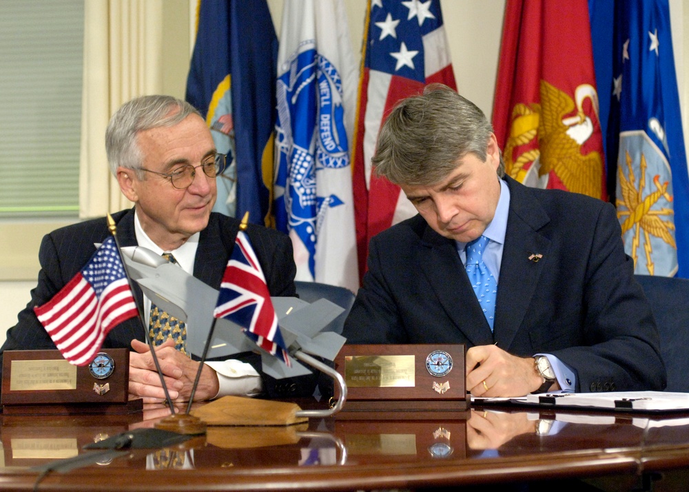 Deputy Secretary England watches as the United Kingdom's Minister of Defence Procurement Lord Paul Rudd Drayson signs a memorandum.