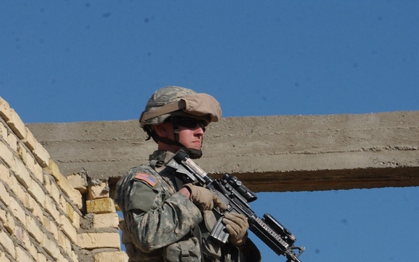 Pfc. Chris Anderson keeps an eye on the street.