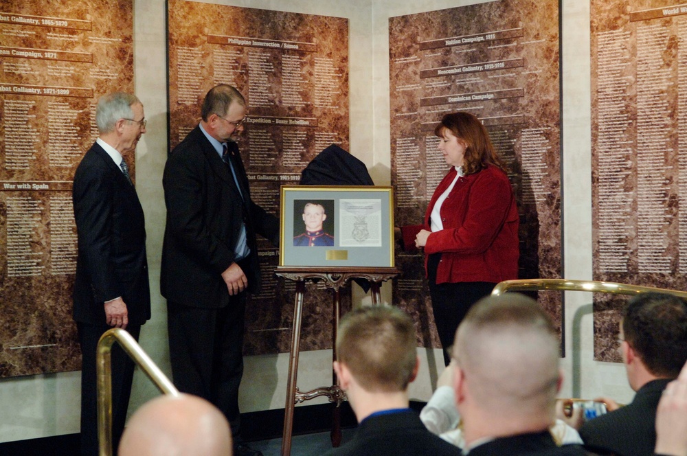 Mr. and Mrs. Dan Dunham unveil the photograph and citation of the Medal of Honor.
